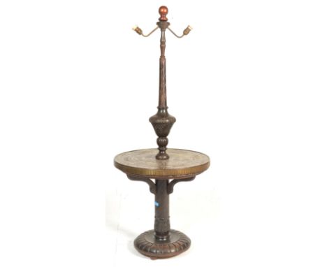 A vintage 20th Century carved standard lamp occasional table, circular base with turned baluster upright adorned with acanthu