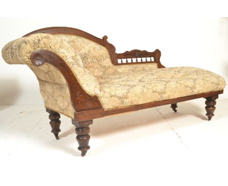 A 19th century Victorian mahogany chaise lounge / day bed with tapestry upholstered button back seat, scrolled back and arm r