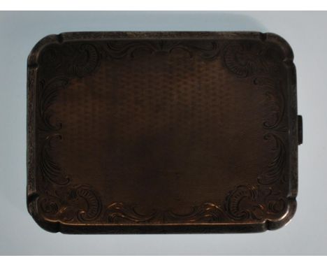 An early 20th century silver 900 marked cigarette case with engine turned decorated centre cartouche within decorated spandre