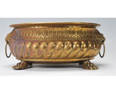 A 19th Century Victorian brass planter of oval having gadrooned decoration to the sides with lion mask twin handles to the si