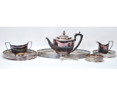 A 20th Century silver plated Elkington three piece tea service to include teapot, creamer and sugar bowl together with a sele