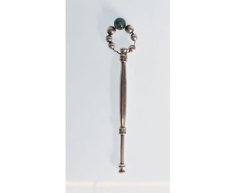 A 20th Century silver hallmarked lace maker's bobbin of slender tapering form having silver beads atop with one central jade 