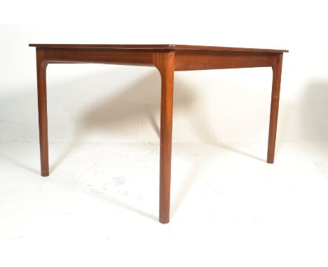 A vintage 20th century retro teak wood dining table by Mcintosh of Kirkcaldy, Scotland. Raised on end legs of square tapering