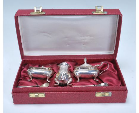 A 20th Century Barker Brothers silver cruet set consisting mustard pot, pepperette, and table sale complete with spoon in ori