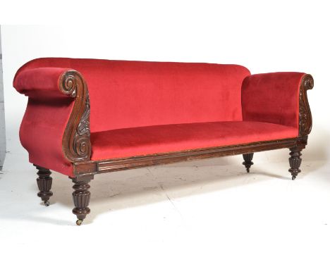 A 19th Century Victorian mahogany carved framed double scroll end sofa settee being upholstered in red velour fabric with but