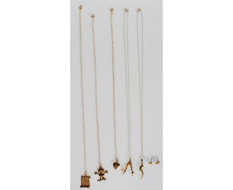 A group on 9ct gold necklaces and chains to include one having a knife, fork and spoon pendant, another in the form of Garfie