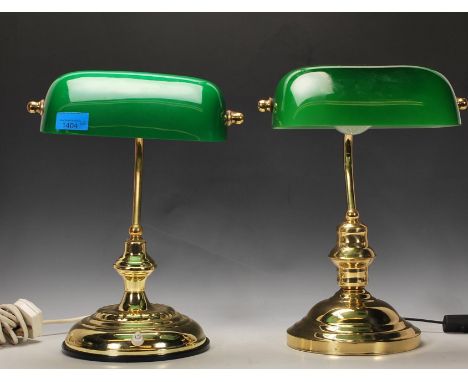 A non matching pair of vintage 20th Century Bankers lamps raised on gilt brass circular bases with adjustable columns and gre