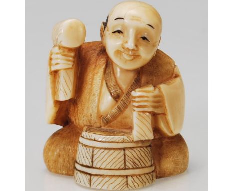 A believed 19th century Chinese carved netsuke in the form of a carpenter with hammer and drum being signed to the base with 