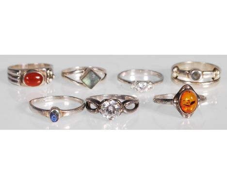 A collection of stamped 925 silver rings to include an amber cabochon ring, a white stone ring with pierced cross over should