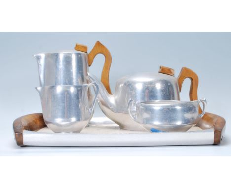 A mid century Piquot ware tea service comprising coffee / teapots tray, bowl and creamer etc as seen in the images. Stamped t