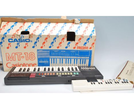 A vintage retro 20th Century Casio Casiotone MT-18 electronic keyboard in original box together with a Realistic Concertmate 