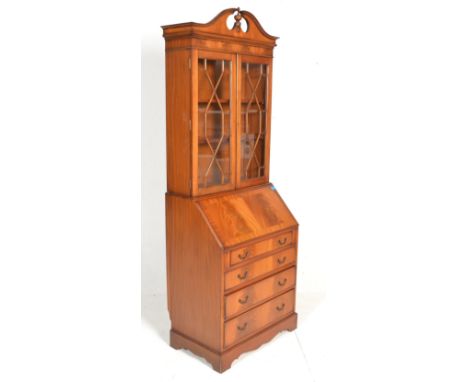 A contemporary Georgian Revival walnut bureau bookcase, glazed doors to the top over full front fully appointed bureau, three