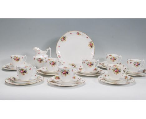 A mid 20th Century Royal Doulton tea service having floral sprays on white ground with gilt rims. The tea set consisting of c