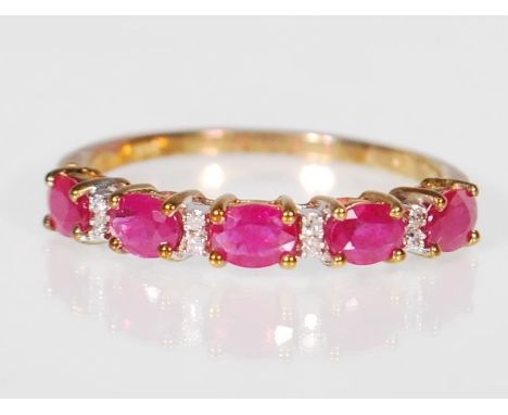 A 9ct gold ruby and diamond dress ring,the ring set with five red stones interspersed with diamonds. Size P weighing 1.6g.