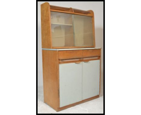 A vintage mid 20th Century kitchen cabinet cupboard in two parts, the lower section having a configuration of drawers over cu
