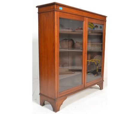 A 19th Century Victorian mahogany library bookcase cabinet having twin full length glazed panel doors housing adjustable shel