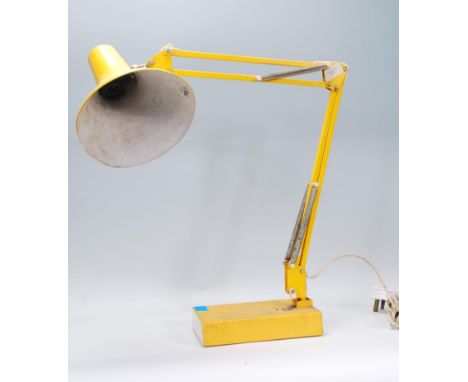 A retro 20th Century Italian Industrial anglepoise desk lamp in a yellow colourway having a&nbsp;conical shade having a cooli