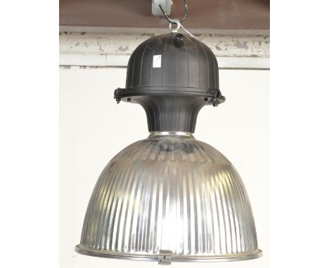 A contemporary large ceiling industrial factory pendant light having a polished aluminium reeded body and perspex cover. Mode