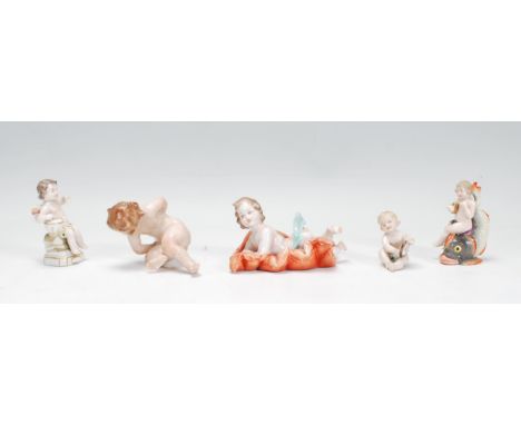 A group of five early 20th Century Capodimonte Naples ceramic figurines in the form of babies / infants including a selection