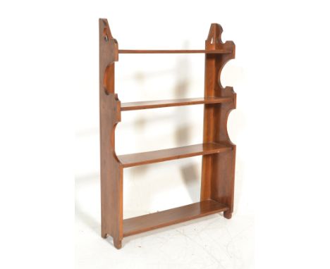 A 19th century Victorian Arts &amp; Crafts solid mahogany set of shelves. The uprights sides of shaped form with pierced corn