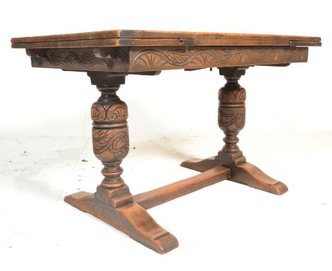 A good quality 20th century oak refectory draw leaf dining table being raised on bulbous turned supports with splayed feet an