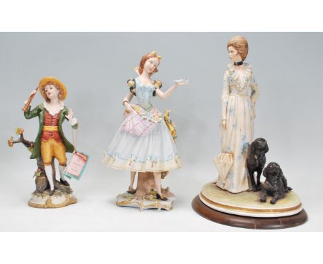 A group of three Italian ceramic figurines to include a Capodimonte limited edition figure by B Merli in the form of a lady w