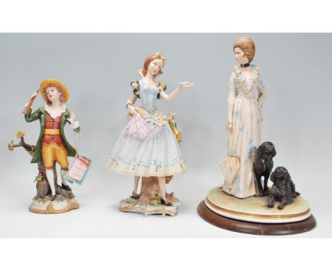 A group of three Italian ceramic figurines to include a Capodimonte limited edition figure by B Merli in the form of a lady w