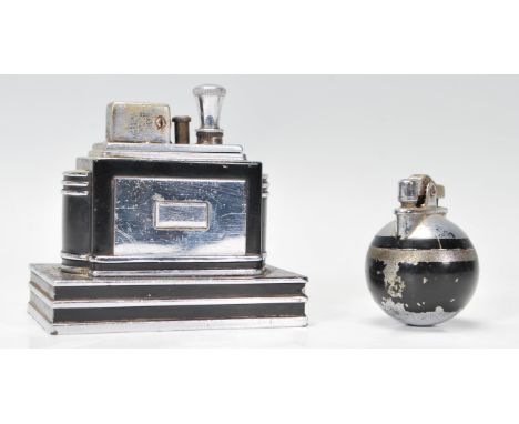 An early 20th Century Art Deco Ronson Touch Tip table lighter of stepped ebonised design together with a small ebonised orb s