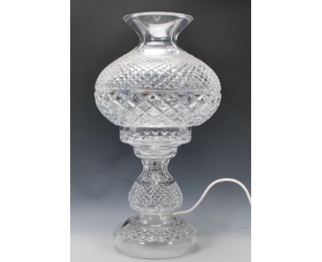 An unused large Waterford crystal two part table lamp with diamond and slice decoration, having a bulbous shade with a flared