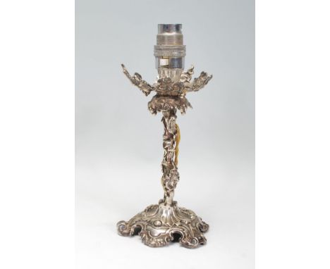 An Elkington &amp; Co silver plated candlestick to lamp conversion in the form of a grape vine raised on a scrolled rococo st