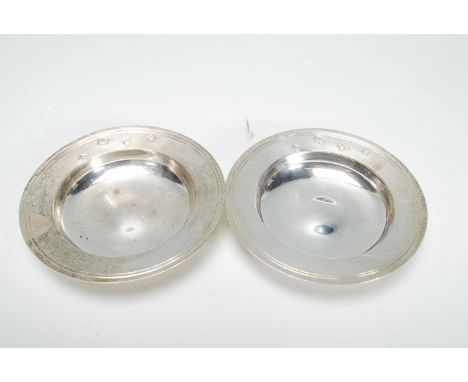 A pair of silver hallmarked pin / trinket dishes of round having engraved dual rim decoration. Hallmarked for London date let