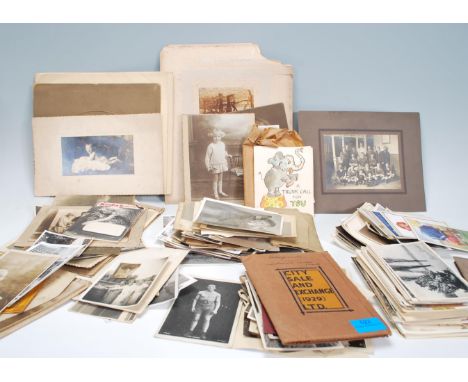 A collection of vintage photographs and postcards, postcards to include portrait, scenic, comic etc. Photos containing many p