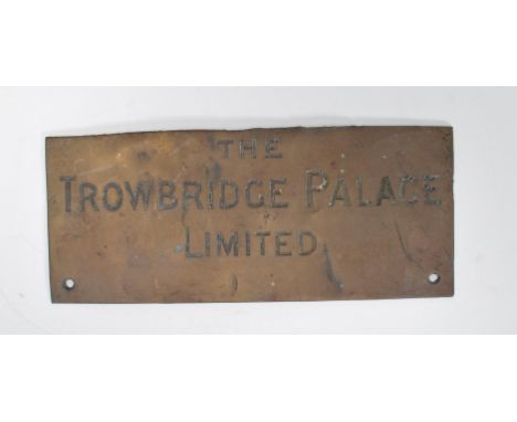 A vintage early 20th Century brass wall plaque of rectangular form with notation in bold letters reading THE TROWBRIDGE PALAC