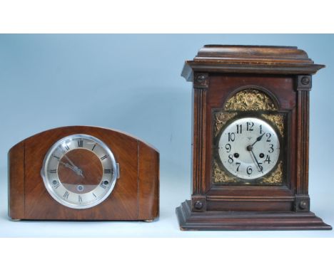A group of three mantel clocks to include a mid 20th Century domed top mantel clock with a round face and enameled chapter ri