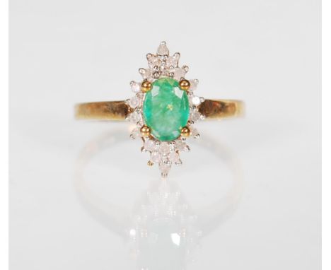 A 9ct gold hallmarked emerald and diamond cluster dress&nbsp; ring, central mounted oval cut emerald surrounded by a cluster 