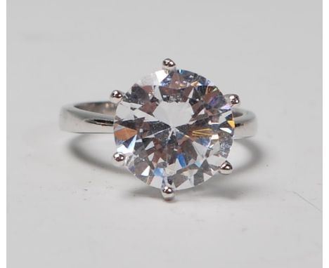 A stamped 925 silver solitaire ring set with a large round cut CZ. Weight 5.4g. Size P.&nbsp;