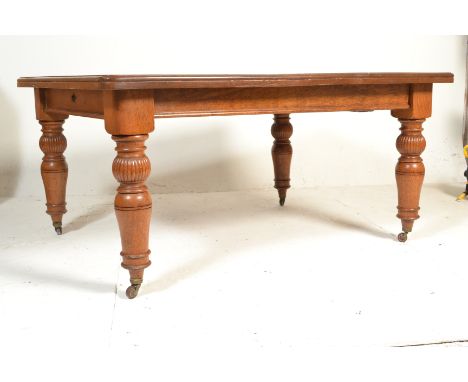 A 19th Century Victorian oak extendable dining table, flared canted frieze raised on turned baluster supports terminating on 