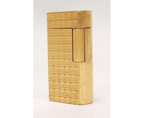 A vintage 20th Century Dunhill model no. 70 gas lighter of rounded oblong form with gold plated textured finish. Marks to bas