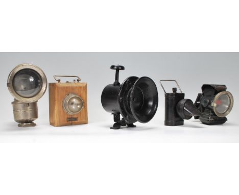 A vintage early 20th century police siren horn together with a a white metal bike lamp, a smaller ebonised bike lamp and a wo