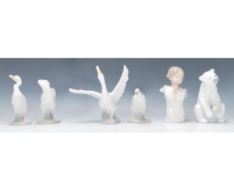 A collection of Lladro figurines to include a Polar Bear, 4 swans / geese and a praying winged cherub / putti. Each being sta