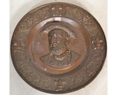 A 19th century large French copper wall charger plate commemorating King Francois I having a repousse bust portrait in high r