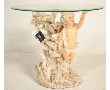 A vintage 20th Century Italian Academy collection side table in the form of a Cherub surrounded with florals having a round g