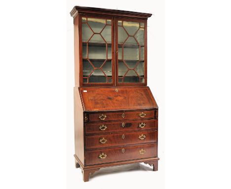 A George III 18th century mahogany and marquetry inlaid cross-banded bureau bookcase. Raised on bracket feet with a bank of d