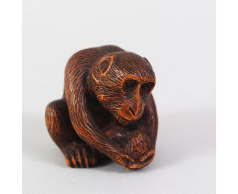 A GOOD JAPANESE MEIJI PERIOD CARVED WOODEN NETSUKE OF A MONKEY BY MASANAO, the monkey in a seated position holding his nut / 