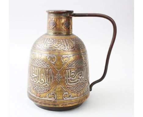 A LATE 19TH CENTURY ISLAMIC DAMASCUS BRASS PITCHER, inlaid in silver and copper, with calligraphy, 24cm high.