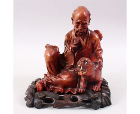 A GOOD 19TH CENTURY CHINESE CARVED WOOD FIGURE OF A SAGE, seated reading from his scroll / book, with a tiger beside him, wit