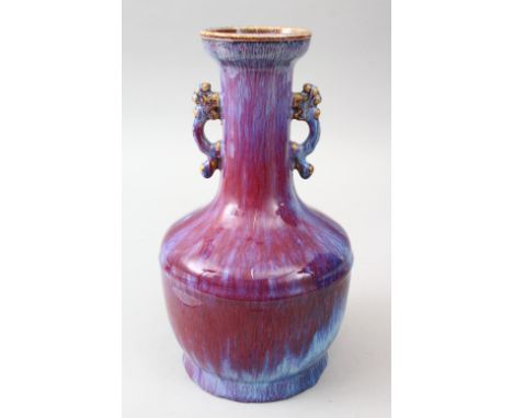 A GOOD CHINESE TWIN HANDLE FLAMBE PORCELAIN VASE, the vase with twin moulded chi long handles, the base with an incised four 