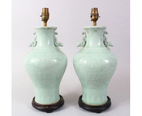 A GOOD PAIR OF 19TH / 20TH CENTURY CHINESE CELADON PORCELAIN VASES / LAMPS, the vases with tin moulded handles and decoration