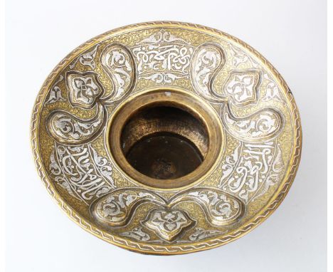 A FINE LATE 19TH CENTURY ISLAMIC DAMASCUS BRASS BASIN, inlaid with silver calligraphy, 32cm diameter.