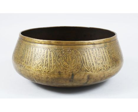 A 14TH / 15TH CENTURY MAMLUK BRASS BASIN, The body with calligraphic decoration, 27cm diameter x 11.5cm high.